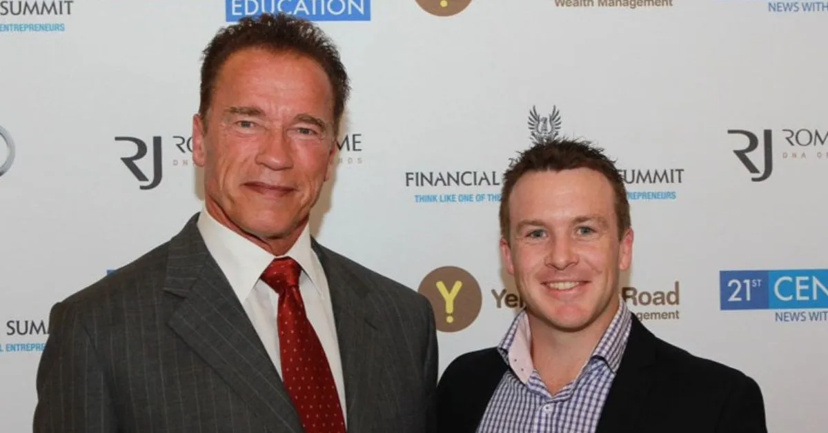 Arnold Schwarzenegger and Dave Burgis pictured together at a fitness education event, representing motivation and success in the fitness industry.