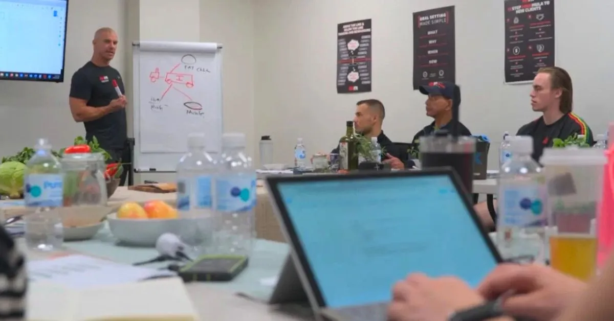 NHFA coach leading a discussion with personal trainers about nutrition and sustainable eating habits.